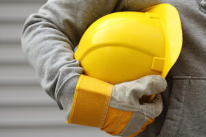 What You Should Do After Getting Hurt at Work - Man holding yellow helmet close up